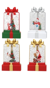 Macro shot of liquid glitter lanterns with snowman and Santa figurines in holiday gift boxes