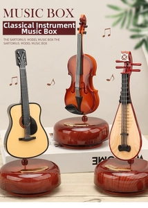 Close-up of vintage musical instrument music boxes with guitar and violin detail
