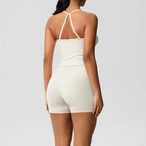 Rear view of cream yoga set showing cross-back sports bra and high-waist shorts texture