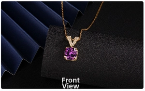Macro shot of gold V-shaped clasp and square purple zircon pendant on a fine chain