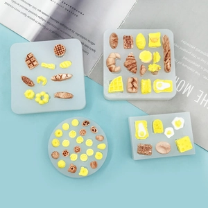 Mini food silicone mold set for croissant and waffle baking with blue background styling