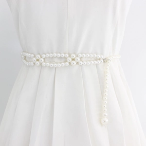 Elegant elastic pearl waist belt for women with metal hook closure on white dress