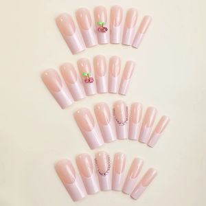 French pink gradient long coffin press-on nails with cherry accents and pink rhinestones