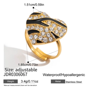Macro detail of adjustable gold stainless steel ring with zebra enamel and zircons