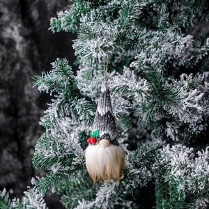 Grey knitted Christmas gnome ornament with white snowflakes and festive berry detail