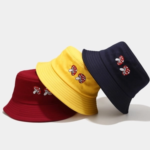 Minimalist canvas bucket hats with mushroom embroidery in red, yellow and navy blue