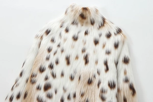 Close-up of white faux fur coat with brown leopard spots and cozy stand-up collar