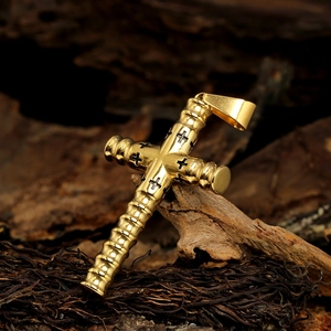 Golden cylindrical cross pendant with black detailing on natural wood background