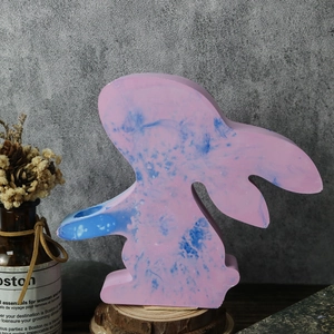 Detailed view of pink and blue marble effect rabbit vase mold on a rustic wood base