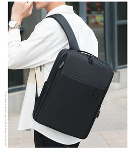 Outdoor shot of man carrying black laptop backpack with USB port and ergonomic straps