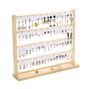 Detailed side view of 4-tier wooden earring organizer with metal hooks and base tray