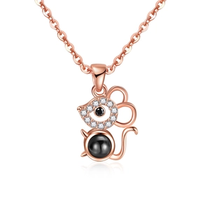 Detail of rose gold mouse pendant with micro-paved zircons and a black polished center bead