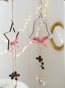 Close-up of Nordic wooden Christmas star and bell ornaments with red plaid ribbons