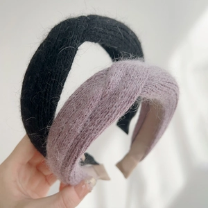 Detailed texture of black and lavender plush knit headbands for winter styling