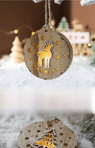 Detail of wooden Christmas ornament featuring laser-cut reindeer and gold foil accents