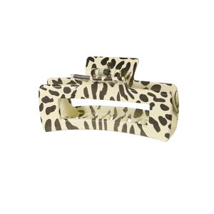 Detail of a large rectangular hair claw clip with vintage beige leopard print and metal spring