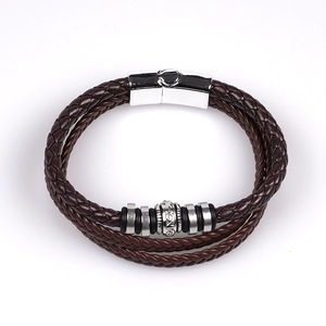 Detail of multi-layer brown braided leather bracelet with silver magnetic metal clasp