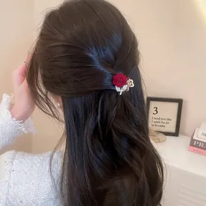 Elegant red flocked rose hair claw clip with crystal gold leaves worn on hair