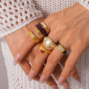 Vintage gold geometric rings with crystals and purple enamel on model's hand