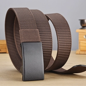 Close-up of brown woven nylon belt with black matte metal buckle on a wooden desk