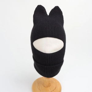 Detail of black knitted cat ear balaclava showing thick ribbed texture and warm face cover