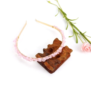 Detail of pink crystal chips on gold handmade wire headband with rose decoration