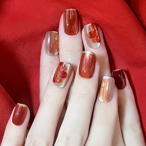 30-piece cat eye press-on nails in festive red and gold floral designs on square oval tips