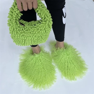 Detail of neon green plush faux fur handbag and matching fluffy slippers in a set