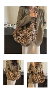 Close-up of a vintage leopard print tote bag with metallic buckle and soft fabric texture