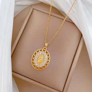 Gold oval Virgin Mary pendant necklace with heart filigree frame and sparkling crystals