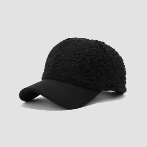 Detail of black faux shearling baseball cap showing fuzzy texture and cotton brim contrast