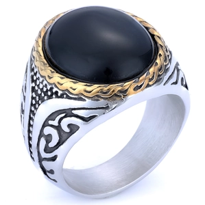 Macro detail of men's silver ring with vintage patterns and oval black gemstone