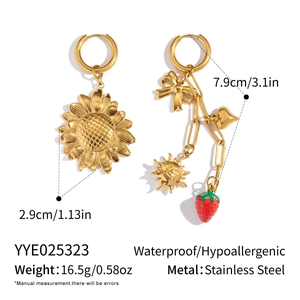 Detailed view of asymmetric sunflower and strawberry earrings in gold stainless steel