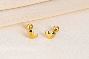 Macro detail of gold S925 silver heart stud earrings with screw ball back closure