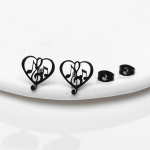 Macro shot of black stainless steel heart studs with cutout music note design details