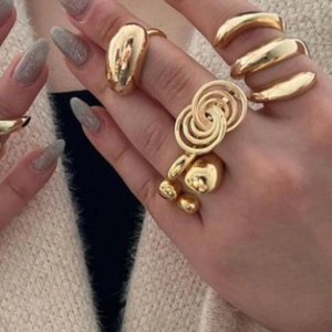 Close-up of a layered 18k gold plated stainless steel ring set on model hand