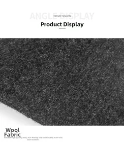 Macro shot of dark grey wool fabric texture showing thick warm thermal material detail