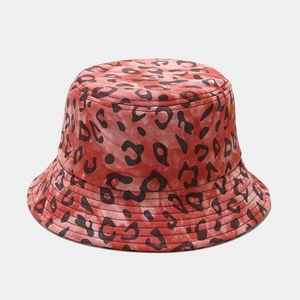 Detailed view of red and black leopard print bucket hat with cotton tie-dye texture