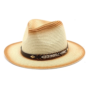 Close-up of a gradient woven straw hat with black leather band and gold stud accents