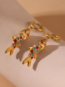 Detail of gold fish hoop earrings with multi-color gems and polished 18k gold plating