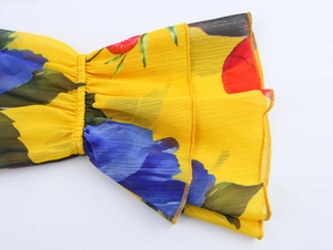 Detail of floral chiffon blouse showing tiered ruffle cuffs and delicate yellow print