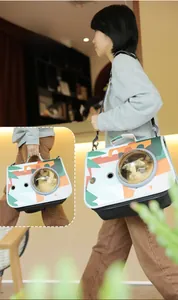 Detail view of the cat carrier featuring a transparent porthole and reinforced air vents