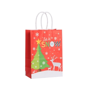 Festive red Christmas kraft paper gift bag with reindeer and snowflake prints