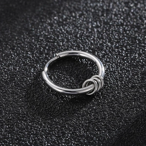 Detail of silver stainless steel hoop earring featuring three small decorative rings