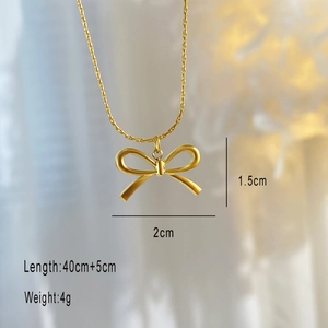 Macro detail of 18K gold-plated bow necklace showing 2cm pendant dimensions and 45cm chain length