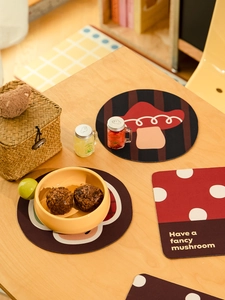 Close-up of mushroom pattern diatom mud coasters with Have a fancy mushroom quote