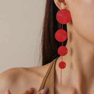 Red long drop earrings with cascading circular textured motifs and delicate metal fringe