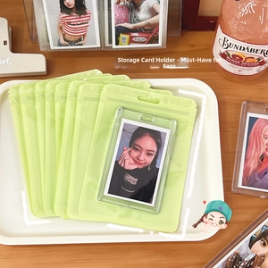 Macro detail of macaron green frosted zip bag and clear acrylic photo card holder set