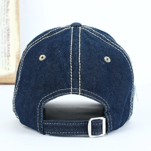 Rear view of dark blue denim baseball cap with contrast stitching and metal buckle