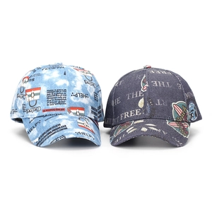 Detailed comparison of two denim baseball caps featuring graffiti prints and urban style